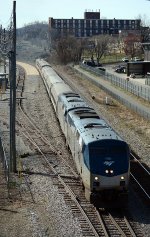 Amtrak #20(13) finally leaves Lynchburg's Kemper Street Station after boarding a large number of passengers.  The former Craddock-Terry West End factory looms in the background